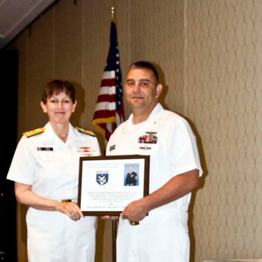 Presented to CTMC (IDW/SW/AW) Gregory G. Neesham, USNR by VADM Tighe