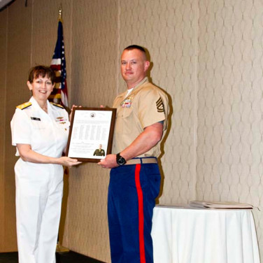 Presented to GYSGT Charles E. Gutensohn by VADM Tighe