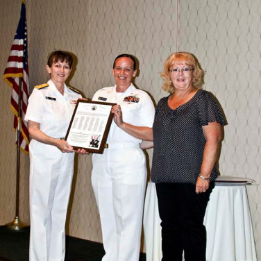 Presented to CTTCS (SW/AW) Sheenah M. Jedrykowski, USN by VADM Tighe and FMC Penny Tardona