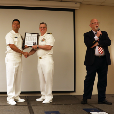 Presented to CTTCS(SW/EXW/IW/AW/PJ) John Mendoza, USN by RADM Daniel J. MacDonnell, Deputy Chief, Central Security Service, National Security Agency