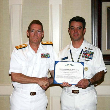 Presented to CTICM(AW/NAC/SW) Ernest T. Ayres by RADM Deets