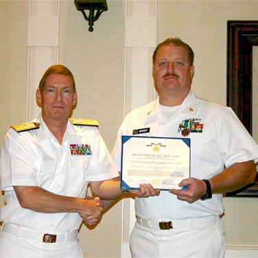 Presented to CTMCM(SS) Brent Barnes by RADM Deets