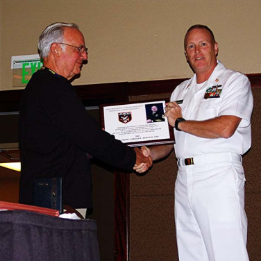Presented to CTACM(SW) Gerald L. Burgess by Grady Lewis