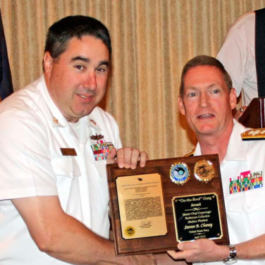 Presented to CTRCM(SW) Steven Chaney by RADM Deets