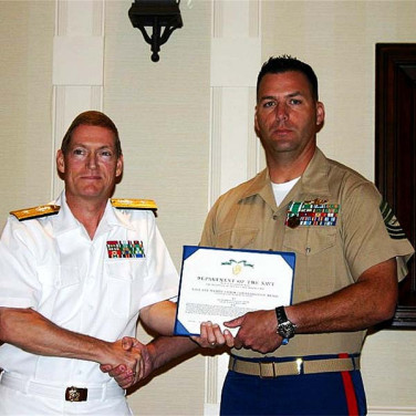 Presented to MSGT Jason Confer by RADM Deets