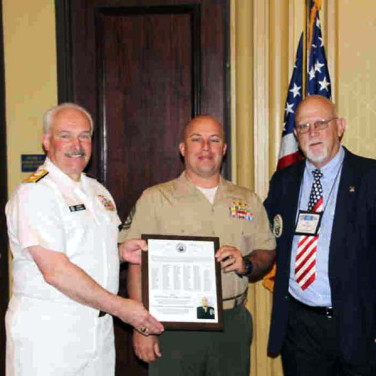 Presented to GYSGT John F. Kirk IV by RADM J. Clusen and Bill Hickey