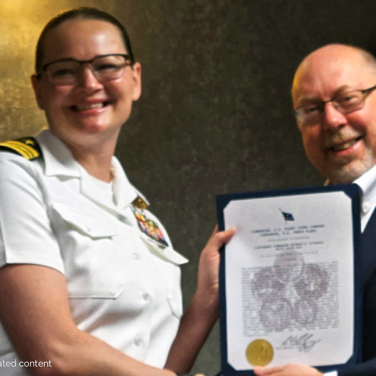 Presented to CDR Nayomie D. Richards, USN, Carrier Strike Group 2 by CAPT Bryan Braswell